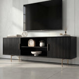 Front view of a modern black TV cabinet with vertical fluted doors, open center shelving, and slim silver legs.