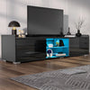 Modern black entertainment console with blue interior in a living room setting.