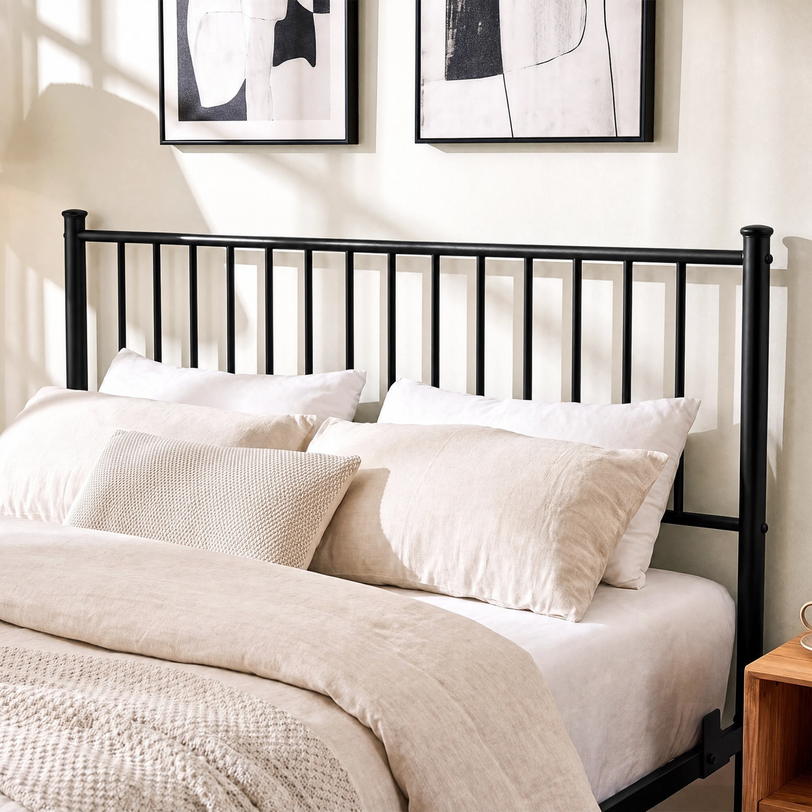 [Black | Double] Black double bed close-up view of tall vertical-bar metal headboard behind layered cream pillows and bedding