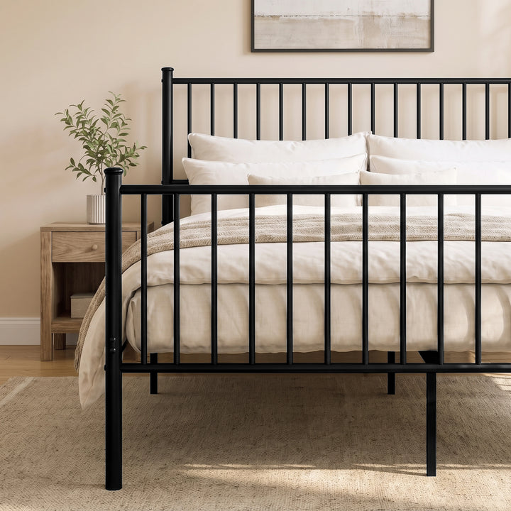 [Black | King] Metal bed front close-up of bar headboard and footboard, white bedding, centre leg, plant and bedside table.