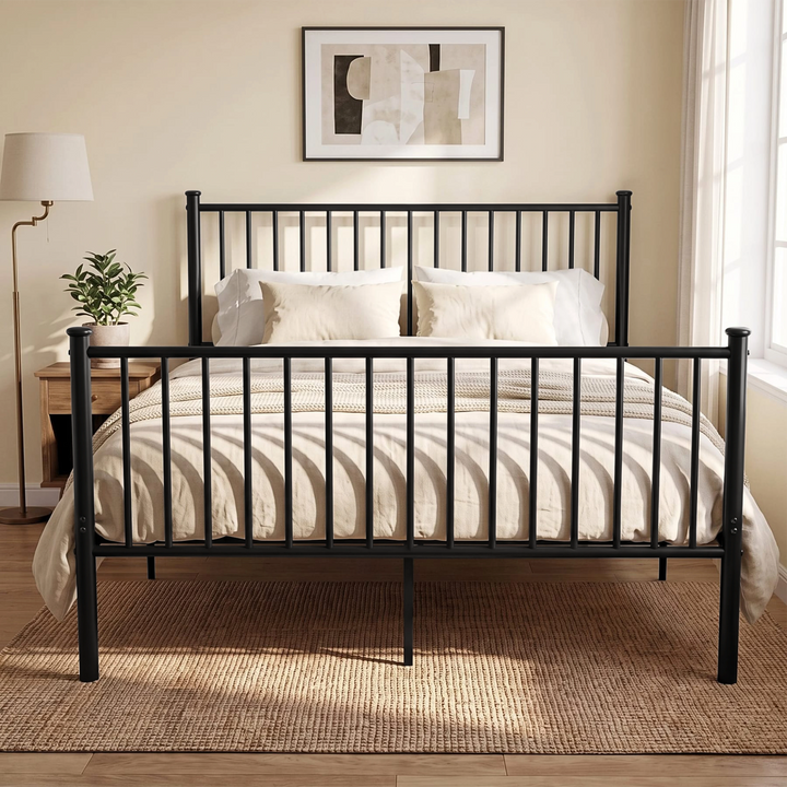 [Black | King] Front view of black metal king bed with white bedding, bar headboard and footboard, centre leg, lamp and plant