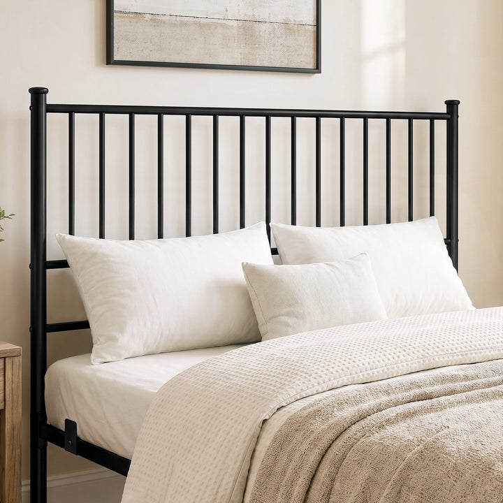 [Black | King] Metal bed close-up view of tall vertical-bar headboard with white pillows & black-and-white abstract wall art.