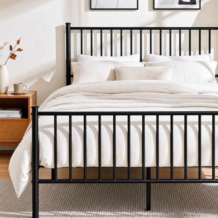 [Black | Double] Metal bed front close-up view of vertical bar footboard, tall headboard, cream bedding & centre support leg.