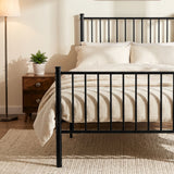 [Black | Single] Metal bed foot-end view with bar headboard and footboard, cream-white bedding, centre leg, lamp and plant.