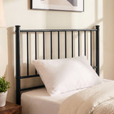 [Black | Single] Metal bed foot-end view with bar headboard and footboard, cream-white bedding, centre leg, lamp and plant.