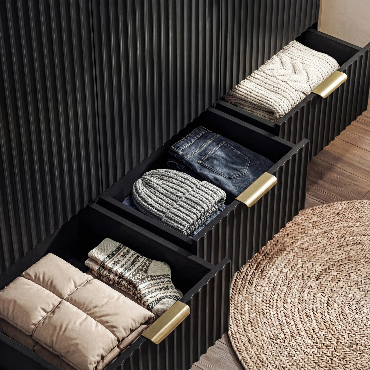 Black flutrina wardrobe with three drawers compartment extended to display folded garments, and storage depth