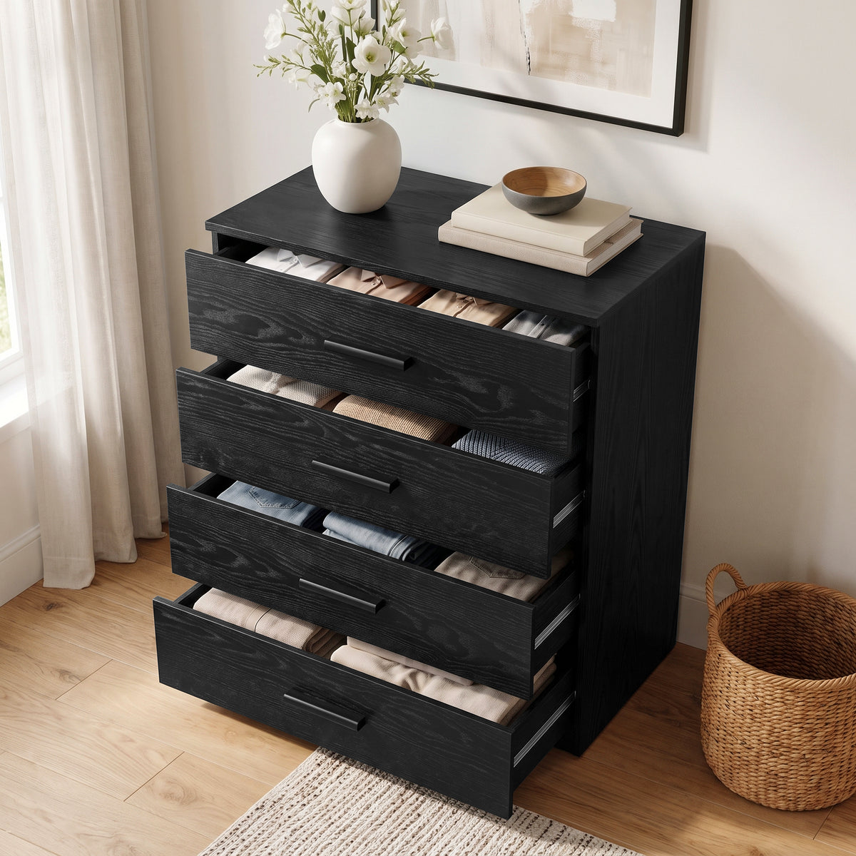 [Black] Angled view of a black wood grain chest of drawers with all four drawers pulled open showing stored clothing items