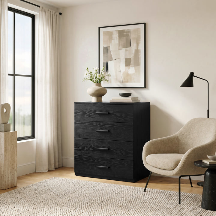 [Black] Black 4-drawer wood grain dresser styled next to a modern armchair and floor lamp in a cozy living room setup