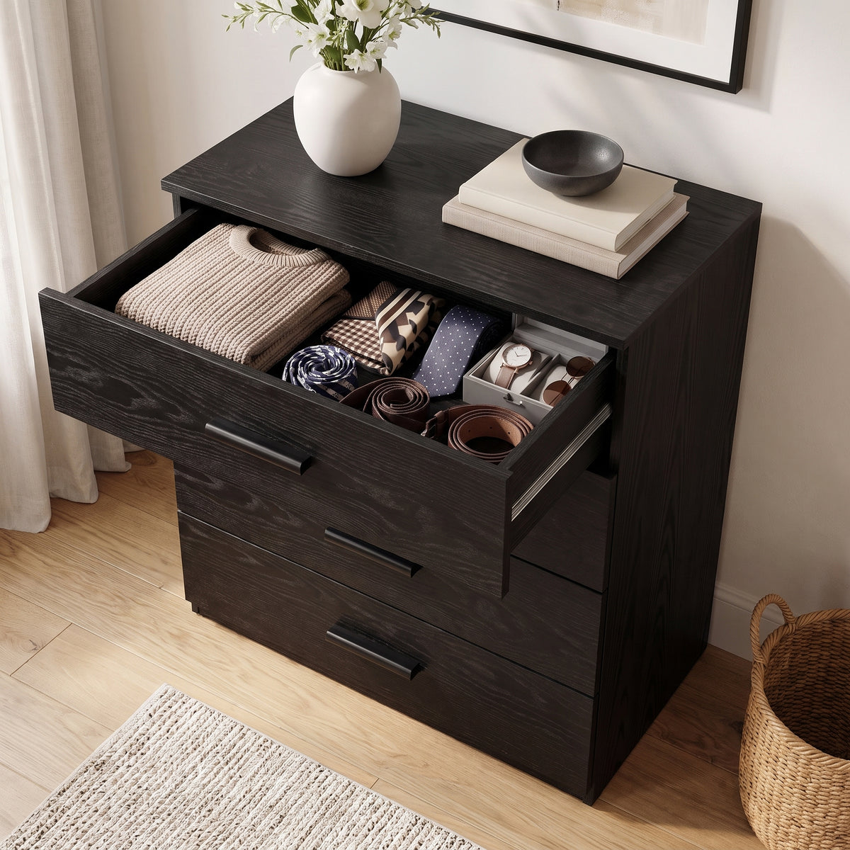[Black] Top-down angle of a black wood grain chest showing the top drawer open with organized ties, belts, and accessories