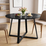 [Black Wood] Round dining table in a bright room with fruit, flowers and candles on top, with two chairs beside it.