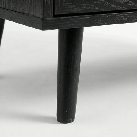 [Black] Wovena bedside table detail showing dark-finished splayed legs