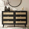[Black] Wovena wide chest front view with six rattan cane drawer panels and dark hardwood knobs in a styled bedroom