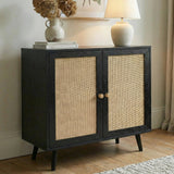 [Black] Wovena sideboard against a neutral wall with a botanical print above, topped with a ceramic vase of dried hydrangeas and a round table lamp