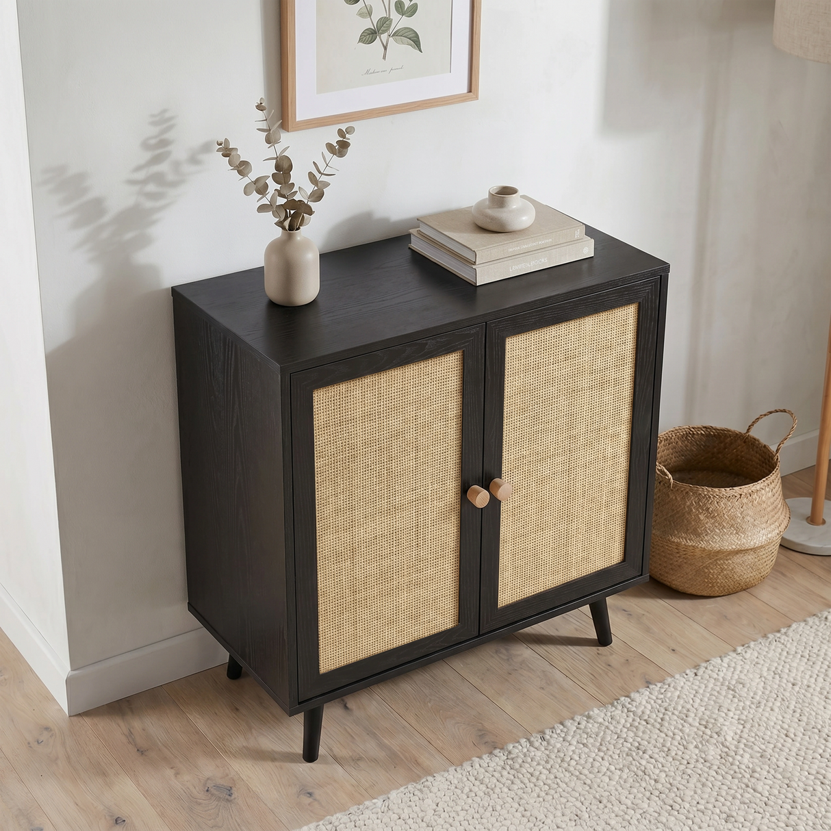 [Black] Rattan sideboard in a light room corner beside a wicker basket and floor lamp, with a vase and books on top