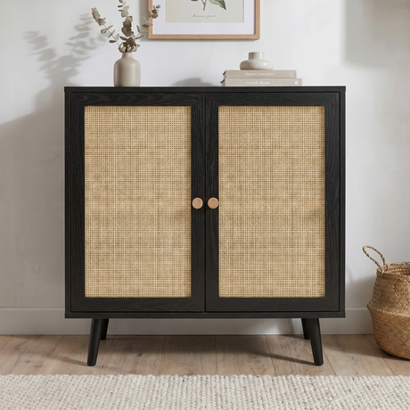 [Black] Rattan 2 door sideboard photographed front-on showing woven cane mesh panels and paired round oak knobs