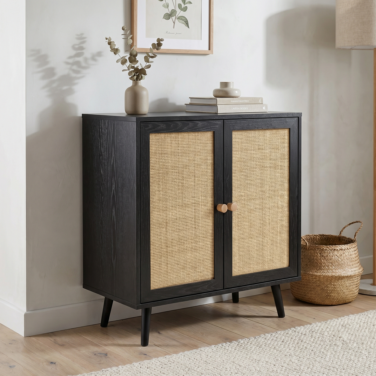 [Black] Rattan sideboard in a warm living room corner with eucalyptus stems, books and a wicker basket