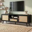 [Black] Wovena Black Rattan TV Unit with 2 Door Storage three-quarter view in sage green room with rattan door panels, central drawer and tapered black legs