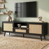 [Black] Wovena Black Rattan TV Unit with 2 Door Storage three-quarter view in sage green room with rattan door panels, central drawer and tapered black legs