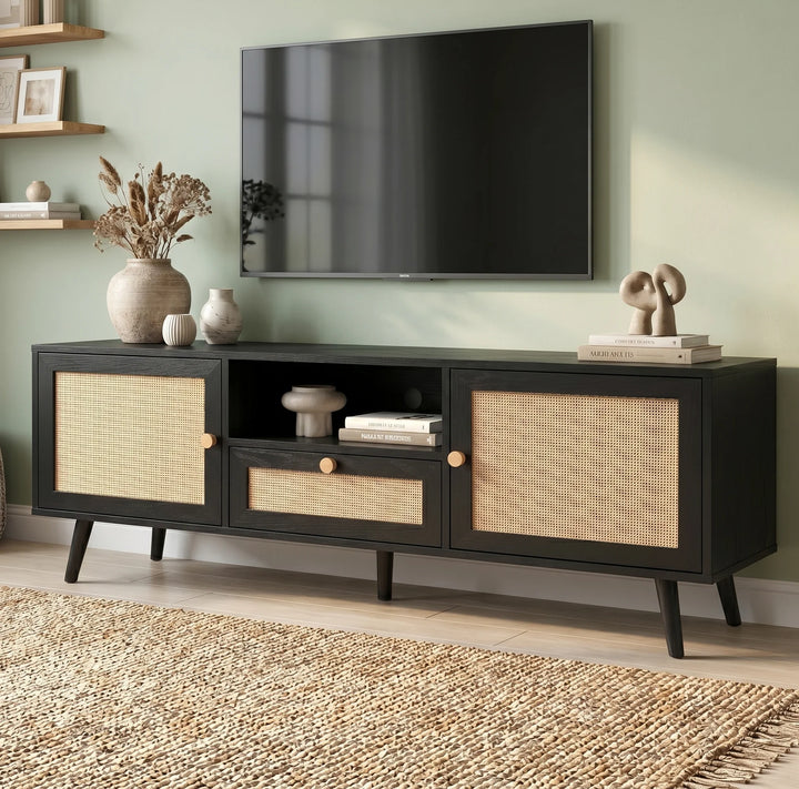[Black] Wovena Black Rattan TV Unit with 2 Door Storage three-quarter view in sage green room with rattan door panels, central drawer and tapered black legs