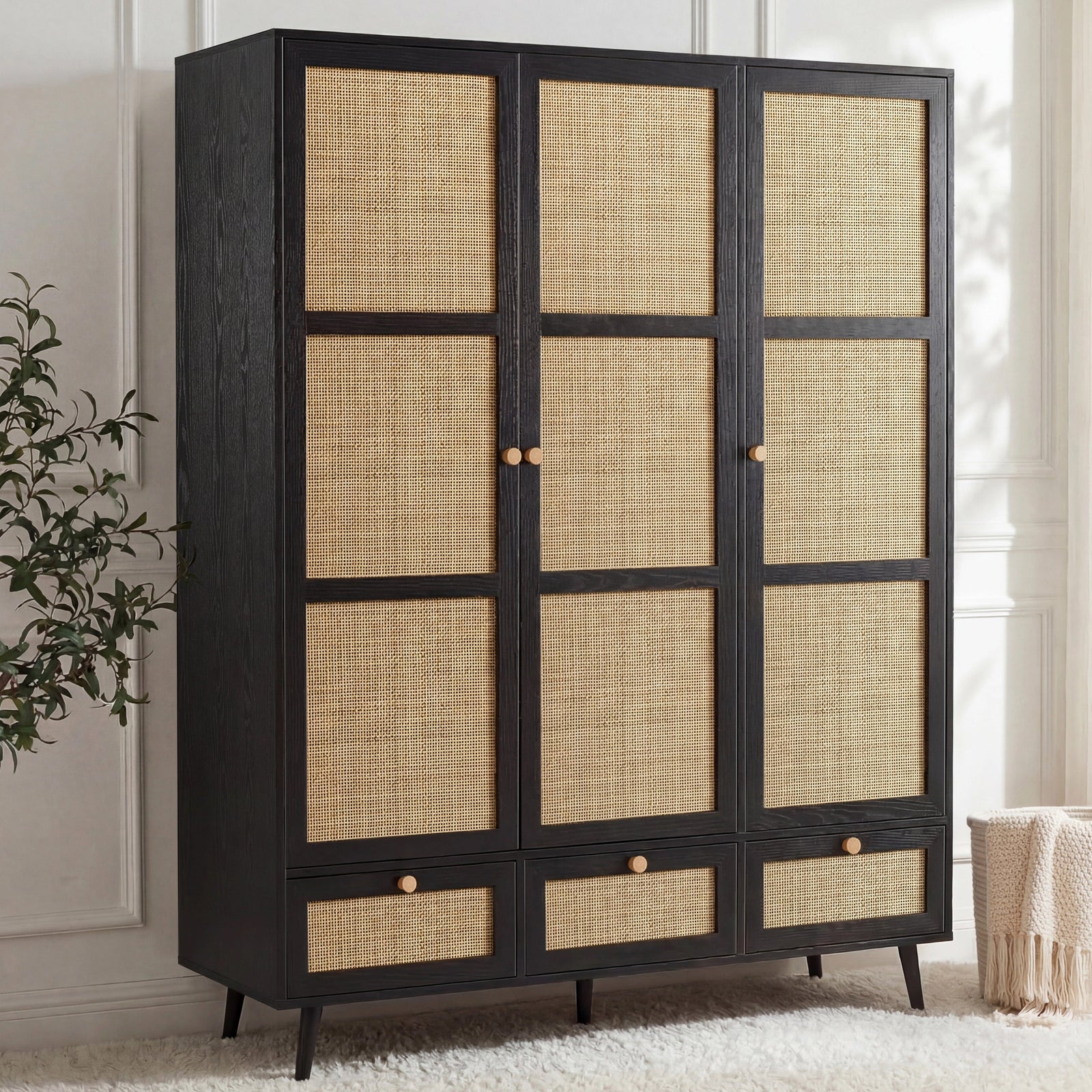 [Black] Three-quarter angle of the black rattan wardrobe with three doors, three base drawers and pine knob handles