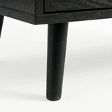 [Black] close-up of a tapered black leg on the Wovena sideboard with wood grain showing through the dark finish