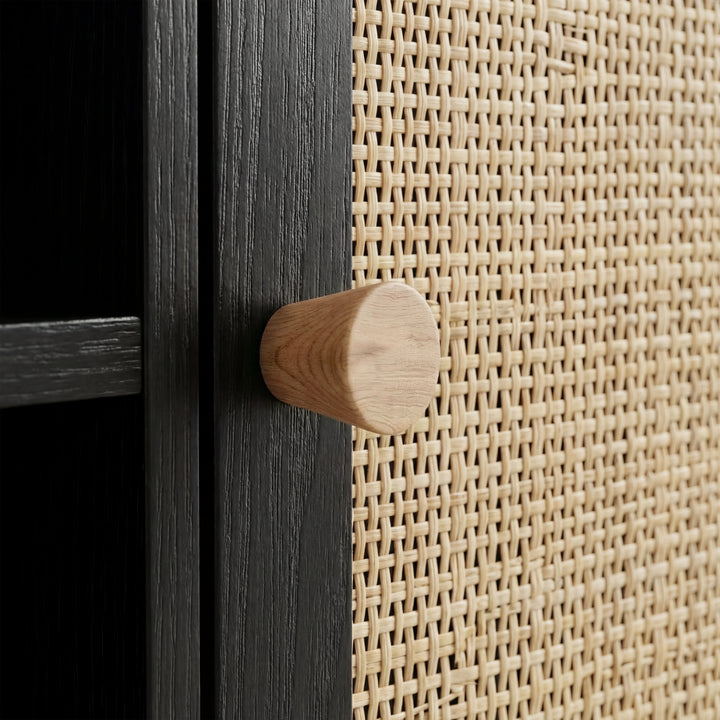 [Black] Wovena TV unit oak cone knob detail, pale wood handle set against natural rattan-mesh door panel weave