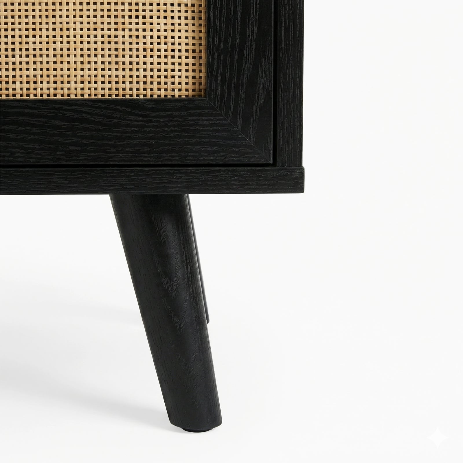 [Black] Detail of Wovena 160cm TV unit splayed leg, solid black turned timber post planted on a white floor