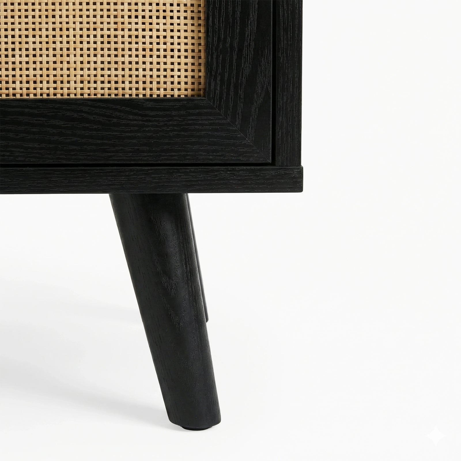 [Black] Detail of Wovena 160cm TV unit splayed leg, solid black turned timber post planted on a white floor