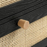 [Black] Macro detail of pine knob fitted to a black drawer rail flanked by woven rattan panels on the wardrobe