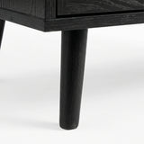 [Black] Underside corner of the black rattan wardrobe showing a single round splayed leg lifting the cabinet