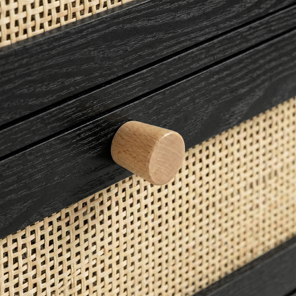 [Black] Wooden drawer knob close-up on Wovena furniture with natural cane weave pattern behind