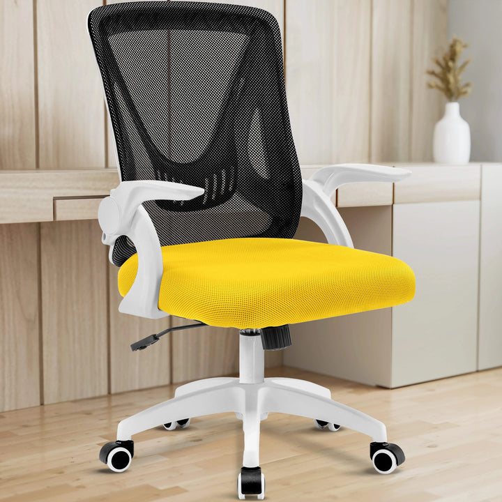 [Black + Yellow] In a home office, the black and yellow mesh chair adds ergonomic comfort, complemented by the working desk.