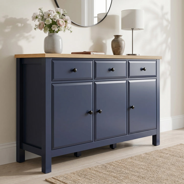 [Blue] Blue 3 Door Sideboard with 3 Drawers, 135cm Oak Veneer Top shown from an elegant low angle.