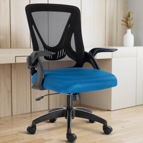 The black and blue mesh chair is set in a home office, with the working desk behind it for ergonomic work comfort.