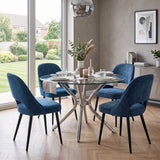 [Blue | Set of 4] Pair of fabric dining room chairs at a marble-effect table set with plates, glasses and a vase.