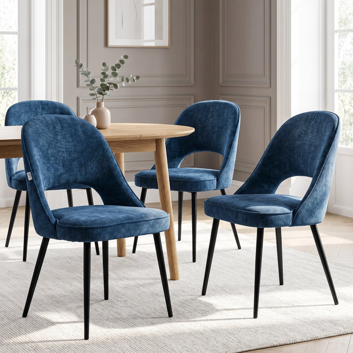 [Blue | Set of 4] Four curved-back dining chairs arranged around a round wood table with a vase and black metal legs.