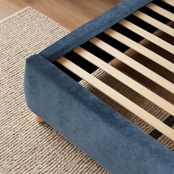 [Double | Blue] A close view of wooden slat support system for the mattress, in the upholstered blue double frame