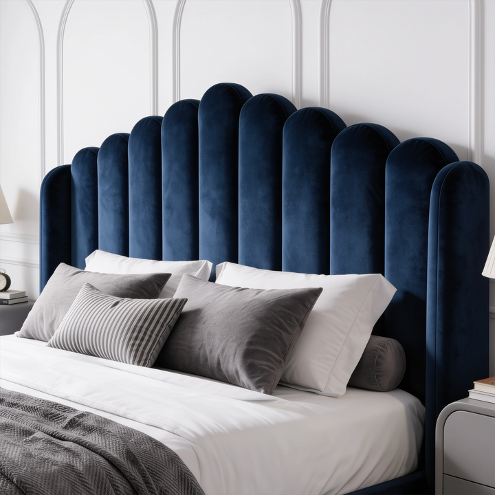 [Double | Blue] Close-up of tall scalloped blue velvet headboard with striped, grey and white pillows