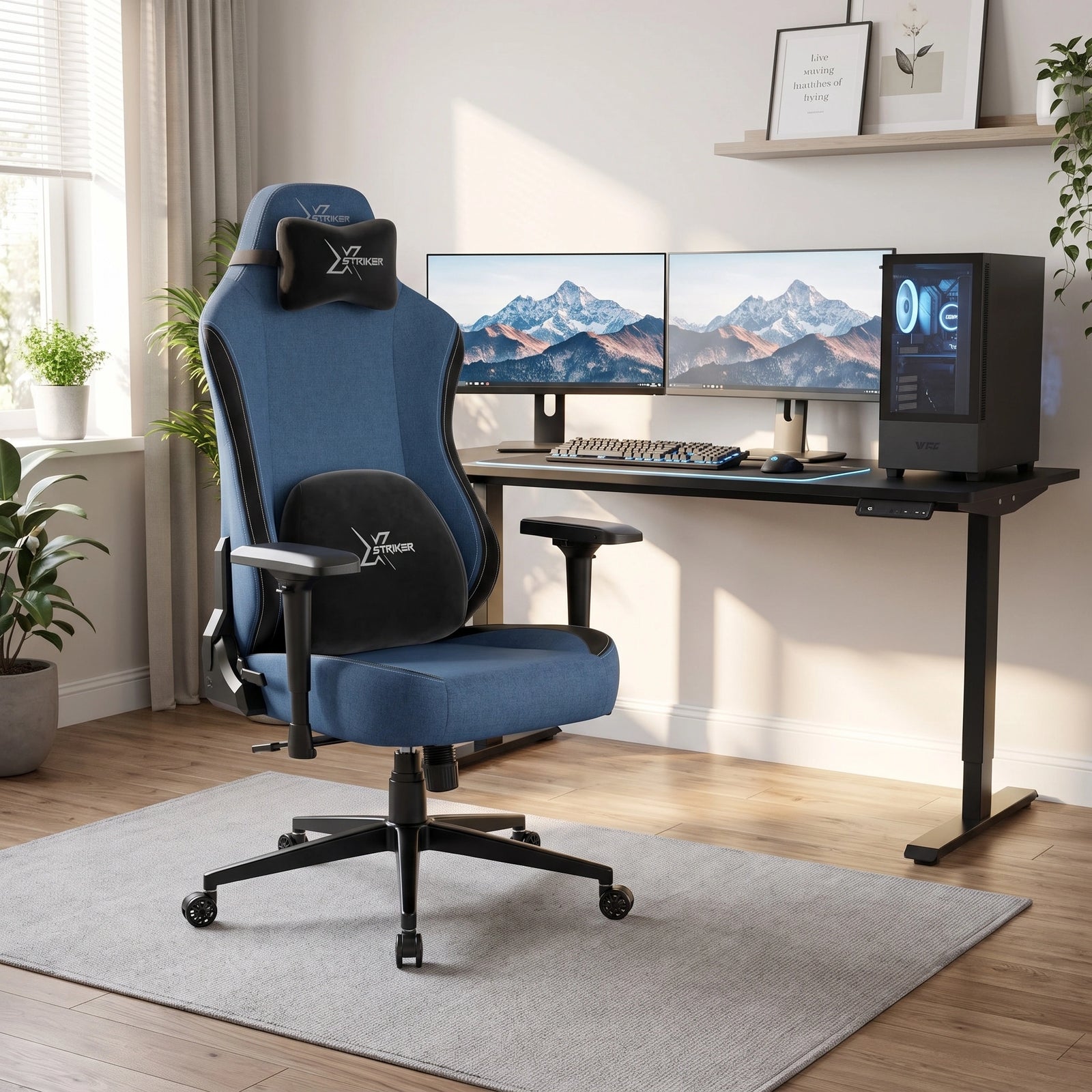 [Blue] ergonomic gaming office chair with black accents and a headrest pillow, positioned in front of a black computer desk setup with dual monitors in a bright home office