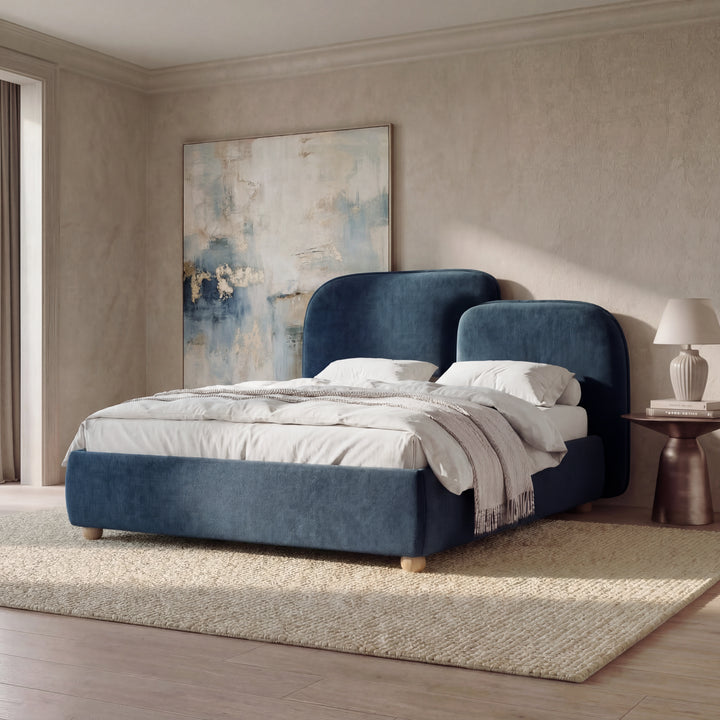 [King | Blue] Side-angle view of a blue fabric king bed, highlighting the low profile base and soft upholstered frame
