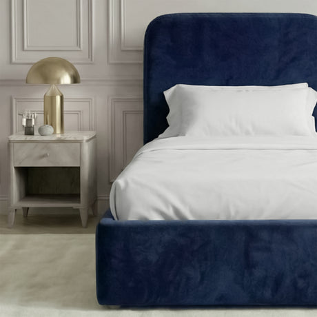 Side and footboard view of blue velvet single bed showing low upholstered base and smooth fabric finish