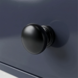 [Blue] Haven chest detail showing a matte black rounded drawer knob set against the deep navy blue painted drawer front