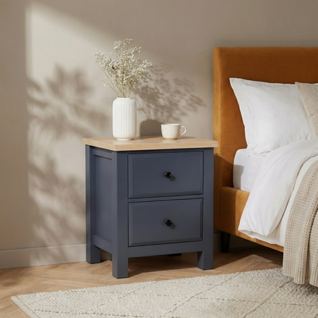 [Blue] Haven bedside table in bedroom corner next to mustard headboard with vase and mug on oak top