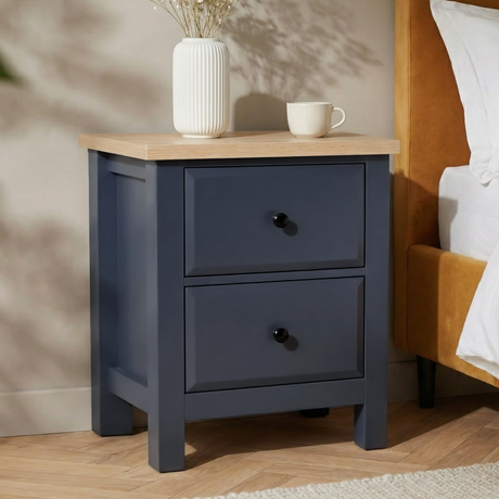 [Blue] Haven bedside table placed beside a mustard bed with both drawer fronts and oak top visible