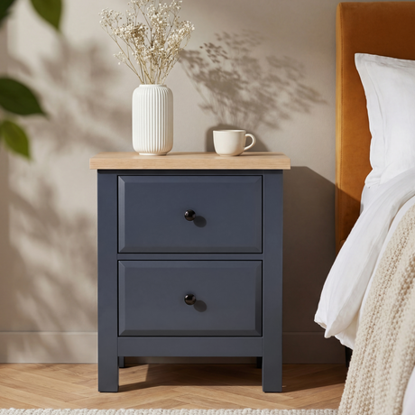 [Blue] Haven bedside table styled in a bedroom next to a mustard headboard with dried flowers on top