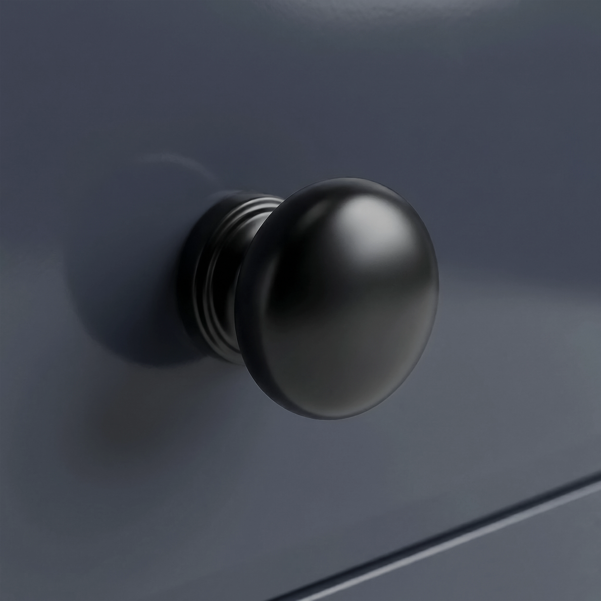 [Blue] Haven close-up of matte black round drawer knob set against navy blue painted drawer front