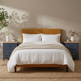 [Blue] Haven bedside tables styled either side of a mustard bed in a warm neutral bedroom setting