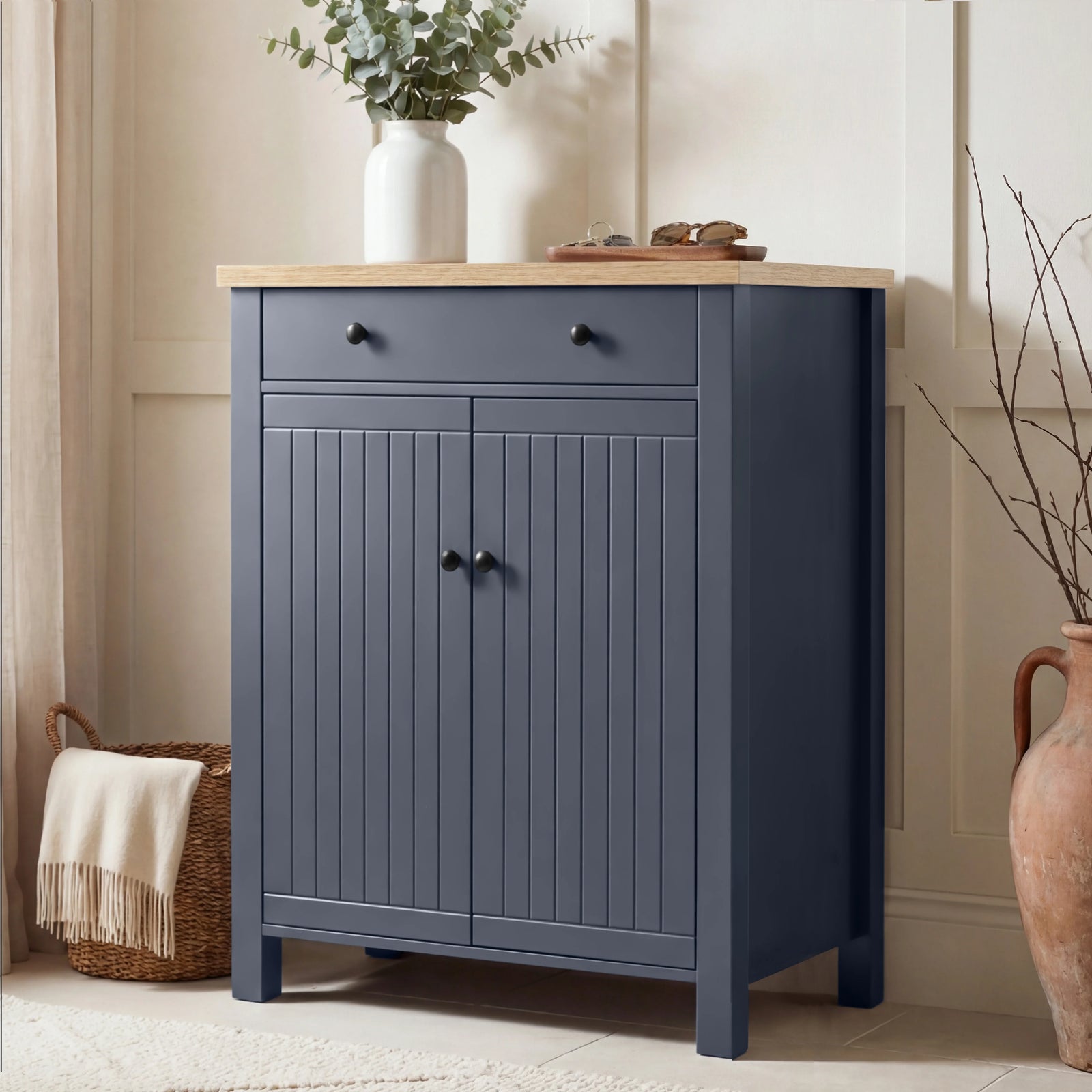 [Blue] Linra shoe storage cabinet in navy with oak top, top drawer with round knobs, and beadboard double-door cupboard below