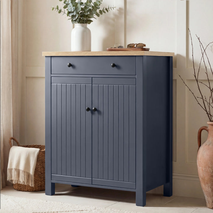 [Blue] Linra shoe storage cabinet in navy with oak top, top drawer with round knobs, and beadboard double-door cupboard below