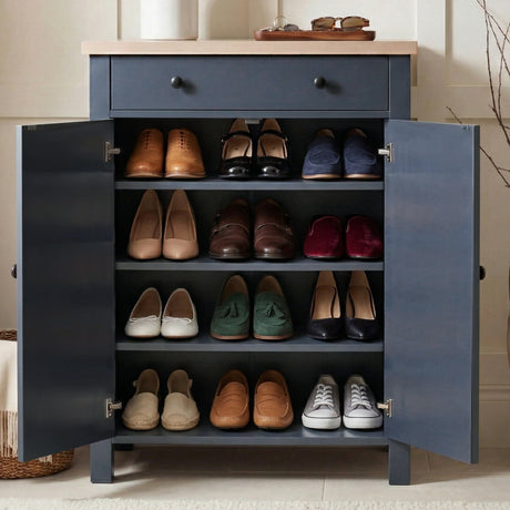 [Blue] Linra shoe cabinet fully open showing four shelves filled with loafers, heels, flats, and trainers in a hallway
